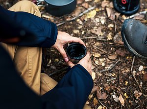 About MensWork. men drinkingtea around fire